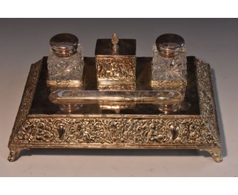 A late Victorian silver-plated rectangular desk stand, the plateau centred by a wafer box, flanked by a pair of mounted cut g