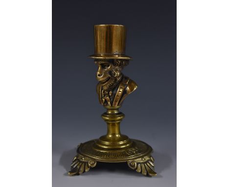 A 19th century novelty taper stick, possibly American, cast as an anthropomorphic ape wearing a top hat, circular base, anthe