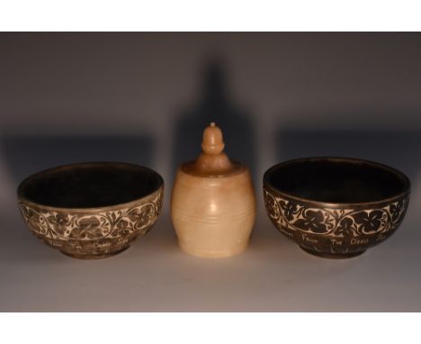 A near pair of pumice stone bowls, carved with a band of scrolling vine and inscribed Stone From The Dead Sea, turned banding