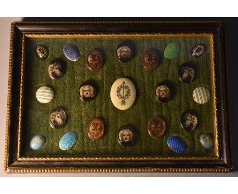 An arrangement of 19th century button mounts, of various designs and decoration, including engine turned enamel, foxes, dogs 