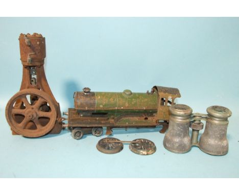 A single-cylinder cast metal steam engine, an O gauge tinplate locomotive in very poor condition and a pair of opera glasses,