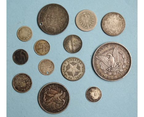 A USA 1890 Morgan silver dollar, New Orleans Mint, a 1918 half-dollar and other silver world coinage. 