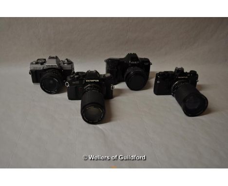 Four cameras with lenses; Camera bodies include: Minolta XG-M, Minolta Dynax 7000i (14215666), Olympus CM40 (1210381) and Oly