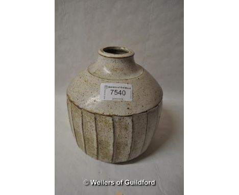 A stoneware fluted vase in the style of David Leach, with white speckled glaze and fluted sides, 17cm.