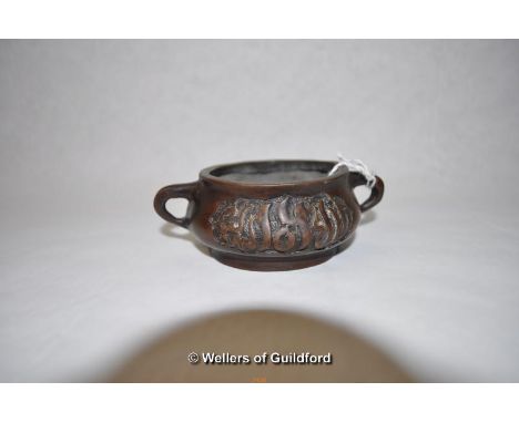 A small Chinese twin handled bronze censor, 10cm wide.
