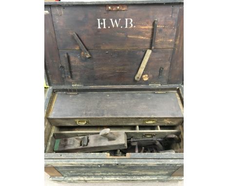 A large carpenters tool box and tools with intitials H.W.B, there is a small label to the inside cover for Paige Motors Ltd, 