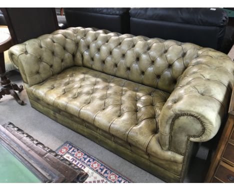 A Green leather upholstered Chesterfield sofa with button back and drop in cushions. Length 186cm