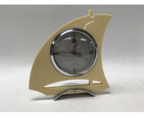A novelty 1950s chrome mounted alarm clock with date aperture in the form of a sail boat. 16cm.