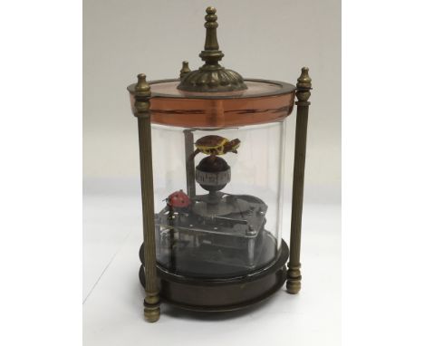A small automaton clock with a tortoise and a ladybird, approx height 16cm.