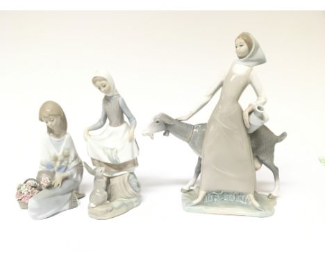 Three Lladro figures in the form of ladies. One kneeling with flowers one with a rabbit and one with a goat. All in excellent