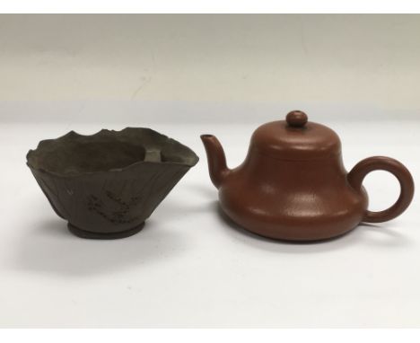 A small terracotta teapot and a tea bowl (2).