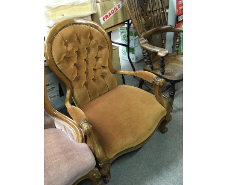 A Victorian style open arm chair with button back draylon upholstery.