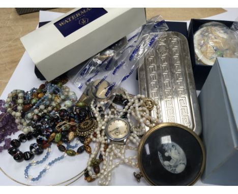 A collection of oddments comprising costume jewellery a Waterman pen pearl necklaces a Vintage Luxor watch and other oddments