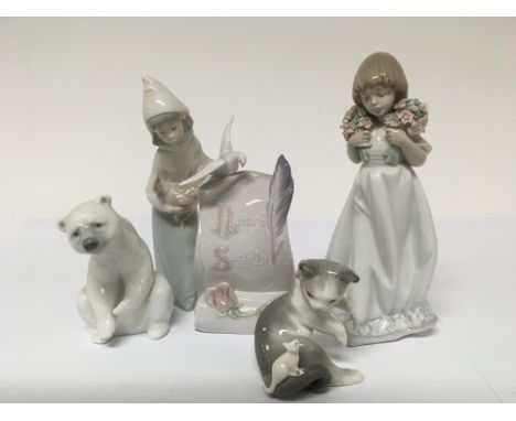 Five Lladro figures. One in the form of a lady holding a Chicken.one in the form of a Polar bear. One in the form of a Cat an
