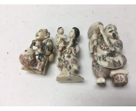 Three Japanese netsuke in the form of a fisherman, god of wisdom and mother and child .