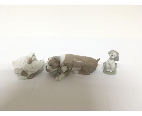 Three Lladro figures one in the form of two ducks one in the form of a dog and cat and one in the form of a dog. All appear t
