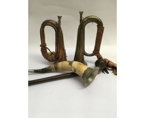 Two brass bugles a hunting horn and a club .