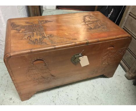 TRUNK, 20th century Chinese camphorwood, with carved decoration, 57cm H x 96cm x 48cm. (slight faults)