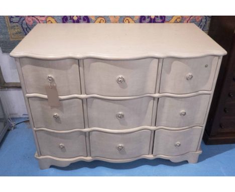 COMMODE, painted of serpentine form with nine drawers, 115cm x 60cm x 87cm H.