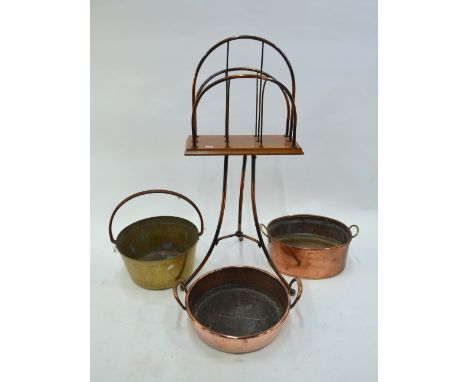 An antique copper and oak tripod two division revolving news rack to/with a trio of old copper pans (4)