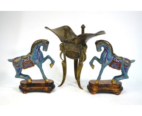 A Chinese archaistic metal jue of tripod form, 20 cm high, together with a pair of Chinese cloisonne enamel horses, each one 