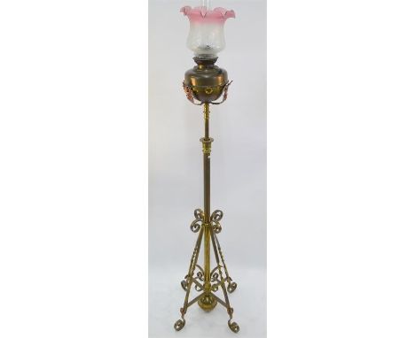 An oil lamp with etched shade, on telescopic brass standard base