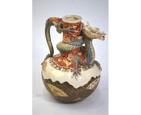 A Satsuma ewer with dragon spout, similar to the preceding lot, decorated with a design of fans floating on waves; 22.5 cm hi