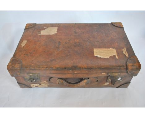 An early 1900s heavy leather suitcase with labels, a heavy leather travel trunk with lettering 'Sir E. Chichester, Instow', a