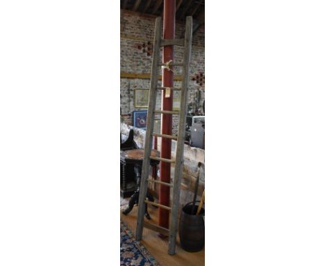 An antique weathered and worn oak ladder of tapering form 228 cm high