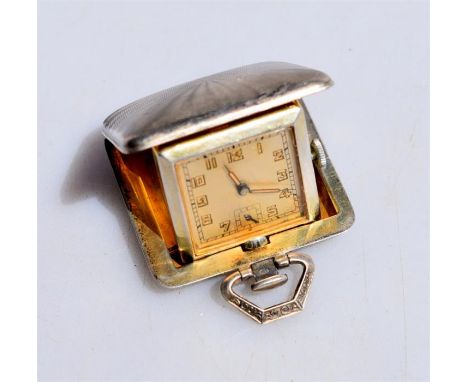 An Art Deco silver and gilt purse/travel watch, the 15-jewel Swiss movement with silvered square dial, in engine-turned foldi