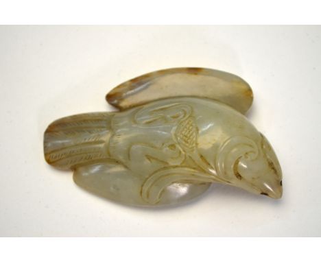 A Chinese mottled green jade, carved as a bird-of-prey, 6.5 cm long, post Qing DynastyExtensive mottled brown russet inclusio