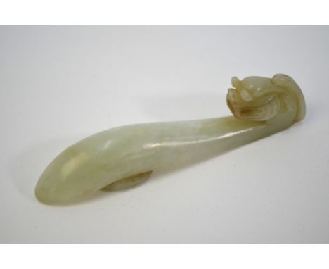 A mottled jade belt hook with mythological animal head and oval boss; 8.5 cm long, Qing Dynasty or laterPlease note that ther