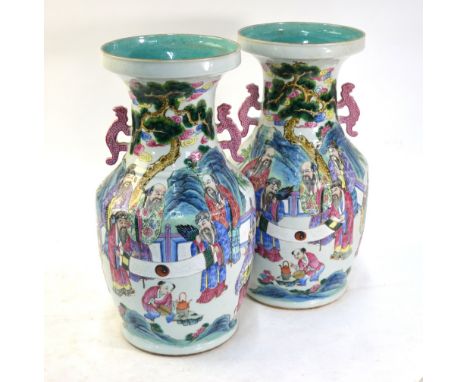 A pair of Chinese famille rose vases; each one with a turquoise interior and decorated with Daoist scholars examining a hands