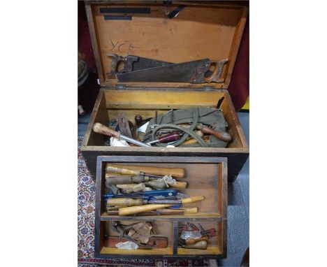 A stained pine tool chest containing vintage tools