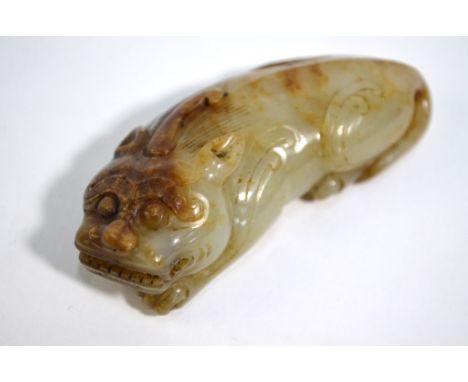 A Chinese&nbsp;mottled green jade figure of a recumbent mythological animal with paws; 7.5 cm long, post Qing DynastyPlease n