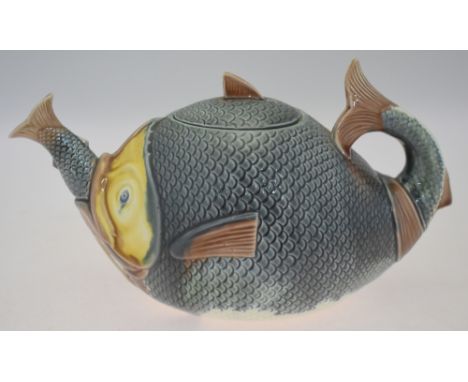 A Majolica style teapot and cover, designed as a large fish swallowing a smaller fish, about 16 cm high