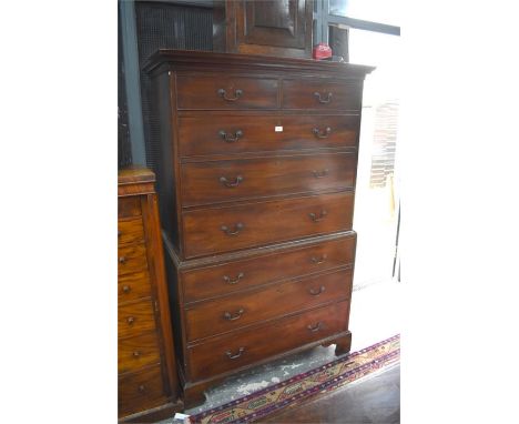 A George III mahogany chest on chest with two short over six long graduated drawers raised on shaped bracket feet, retaining 