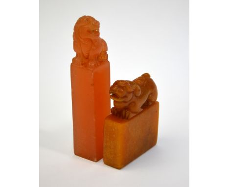 Two Chinese soapstone, or other, seals; each one surmounted by a mythological animal; the taller seal about 13 cm high (2)