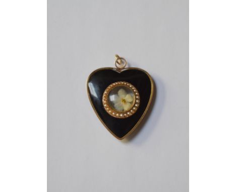 A Victorian black enamel heart-shaped mourning locket, the central circular open locket with seed pearl surround enclosing tw