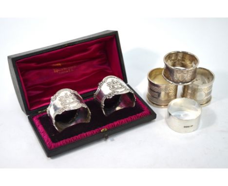 A Victorian cased pair of silver napkin rings, cast with the shield and motto of the Leathersellers Company, Mappin &amp; Web