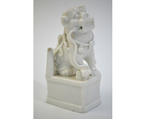 A Blanc-de -Chine joss-stick holder, designed as a Buddhist lion on a rectangular plinth, 13 cm high, Qing DynastyPlease note