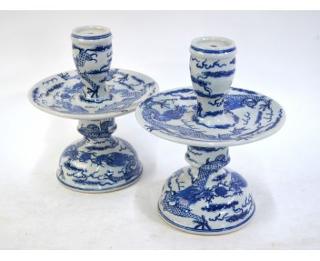 A pair of modern, blue and white, candle or joss-stick holders; each one with circular plate decorated with confronting five-