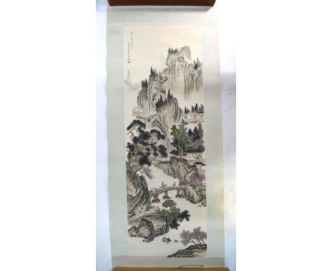 A Chinese scroll picture depicting a scholar riding a mule across a bridge in a mountainous, river landscape with inscription