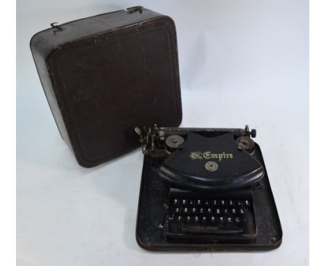 A vintage typewriter, 'The Empire', with tin carrying case