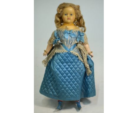 A Victorian wax-headed costume doll with blond wig and blue glass eyes, pierced ears, wax fore-limbs on stuffed hessian body,