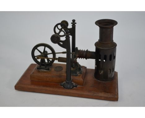 A model static steam engine, Ernst Plank, with twin piston flywheel crank and overhead wheel-driver, on stained pine base, 16