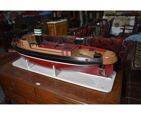 A large pond-model of a coastal steamship, with electric motor and remote control unit, but lot includes original steam engin