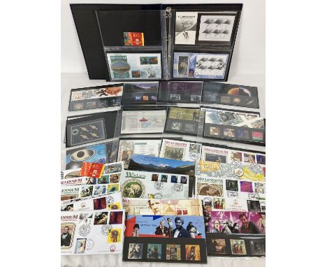 A blue folder containing 23 Royal Mail and Benham mint collectors stamps sets or stamp books complete with corresponding firs