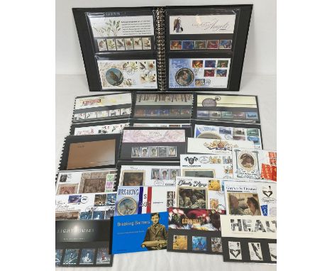 A Black folder containing 13 Royal Mail mint collectors stamp sets or stamp books complete with corresponding first day cover