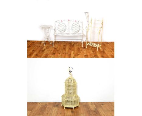 A collection of contemporary wrought metal furniture painted in a white colourway comprising of a bench decorated with pink f